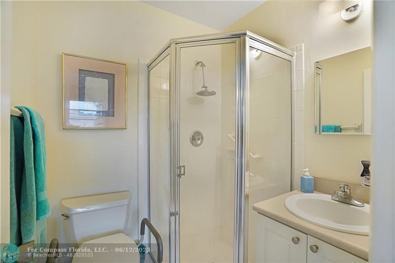 8625 Boca Drive, Unit 12 Boca Raton, FL 33433 - Photo 14 of 42 a bathroom with a shower a sink and a mirror