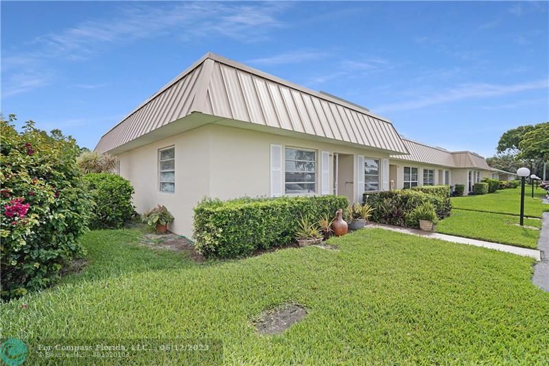 8625 Boca Drive, Unit 12 Boca Raton, FL 33433 - Photo 2 of 42 a front view of a house with a yard