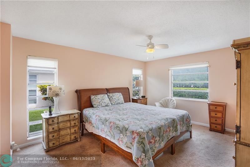 8625 Boca Drive, Unit 12 Boca Raton, FL 33433 - Photo 21 of 42 a bedroom with a bed and a dresser