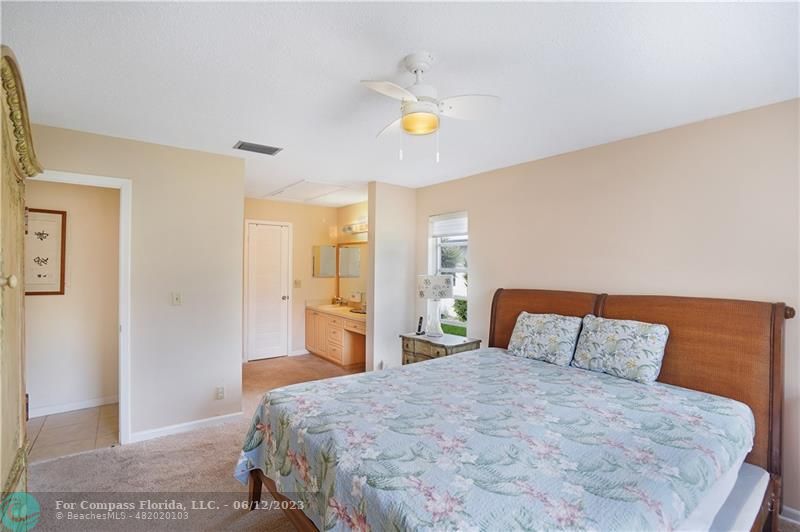 8625 Boca Drive, Unit 12 Boca Raton, FL 33433 - Photo 23 of 42 a bedroom with a bed and painting on the wall