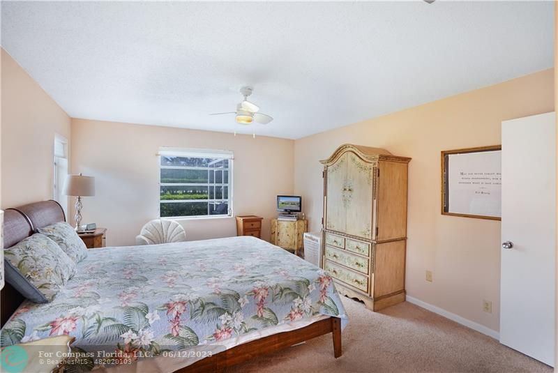 8625 Boca Drive, Unit 12 Boca Raton, FL 33433 - Photo 26 of 42 a bedroom with a bed dresser and a window