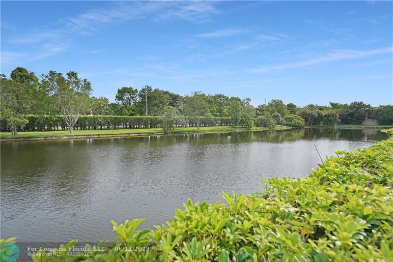 8625 Boca Drive, Unit 12 Boca Raton, FL 33433 - Photo 29 of 42 a view of a lake with houses in the back