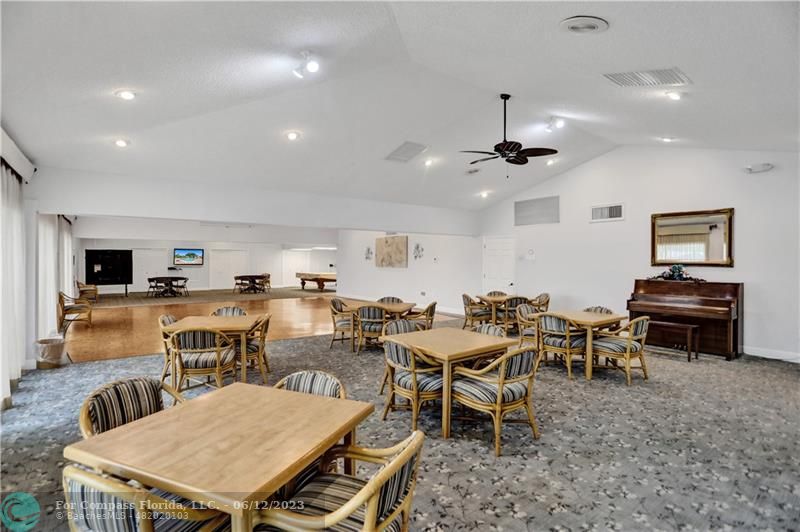 8625 Boca Drive, Unit 12 Boca Raton, FL 33433 - Photo 35 of 42 a living room with furniture a flat screen tv and kitchen view