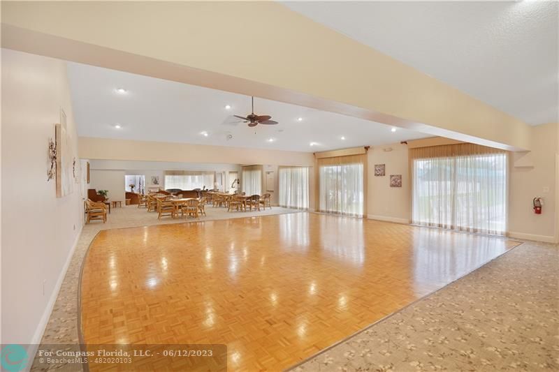 8625 Boca Drive, Unit 12 Boca Raton, FL 33433 - Photo 37 of 42 a view of a kitchen with a sink and a table and chairs