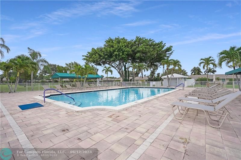 8625 Boca Drive, Unit 12 Boca Raton, FL 33433 - Photo 38 of 42 a view of a swimming pool with a patio and a yard