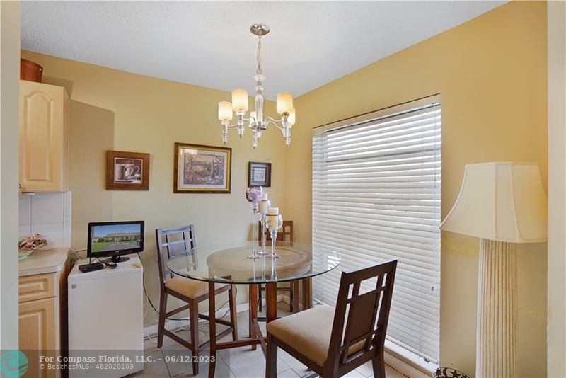8625 Boca Drive, Unit 12 Boca Raton, FL 33433 - Photo 8 of 42 a dining room with furniture and chandelier
