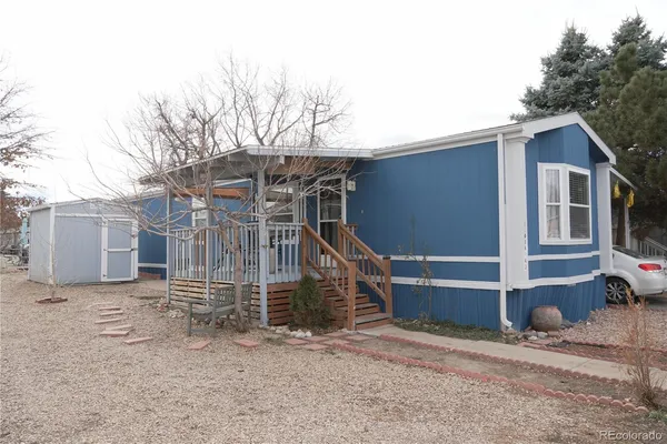 a view of a house with a yard and wooden fence
