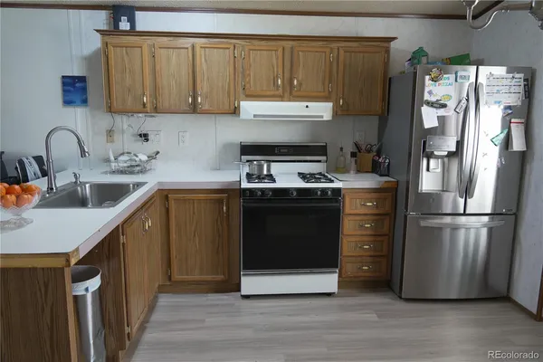 a kitchen with a refrigerator stove and sink