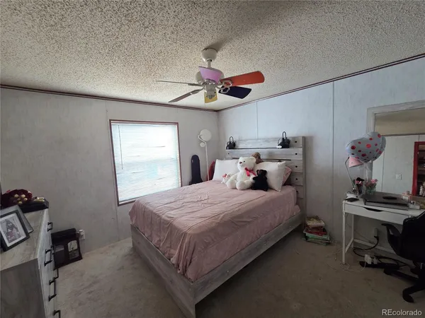 a bed room with a bed and a window