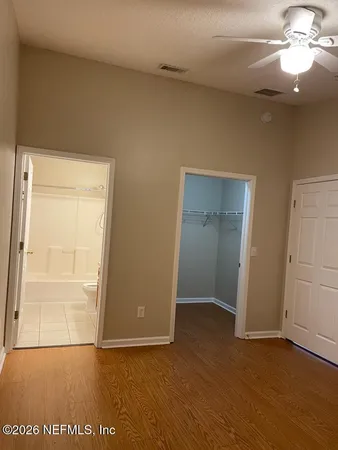 an empty room with wooden floor and door