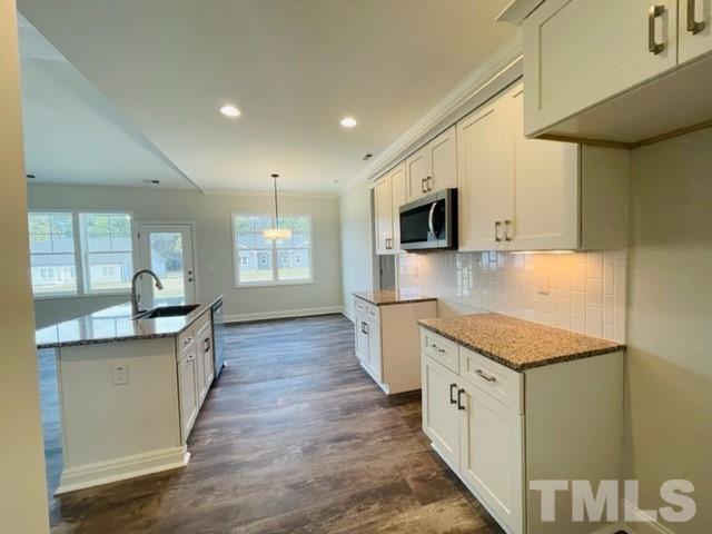 5770 Stott Street Bailey, NC 27807 - Photo 9 of 16 a kitchen with granite countertop a sink and a stove top oven