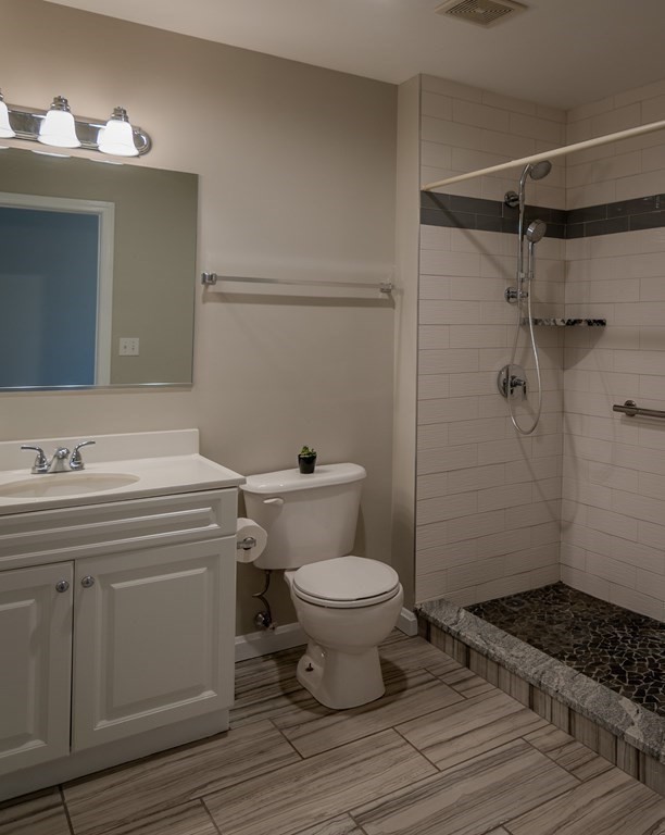 38 Village Road, Unit 615 Middleton, MA 01949 - Photo 11 of 23 a bathroom with a sink toilet and shower