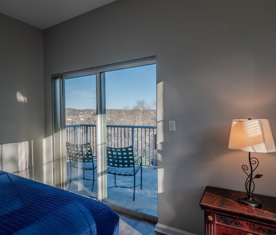 38 Village Road, Unit 615 Middleton, MA 01949 - Photo 15 of 23 a bedroom with a bed a lamp and a window