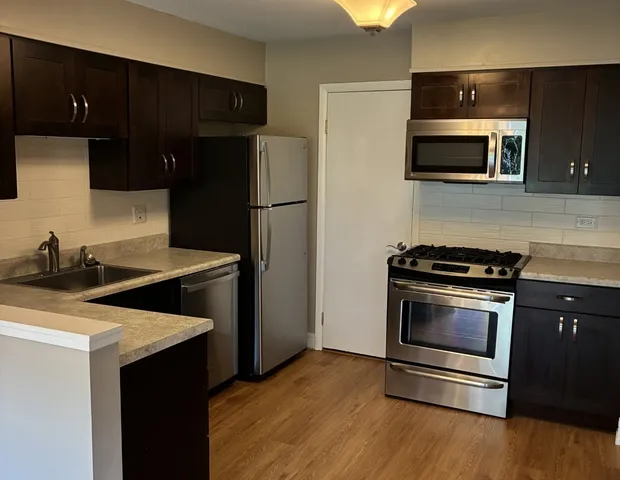 a kitchen with a sink stove and refrigerator