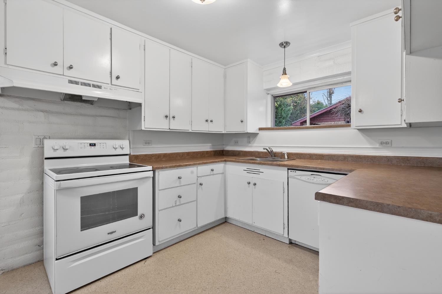 1140 West Lincoln Road Stockton, CA 95207 - Photo 13 of 45 a kitchen with granite countertop white cabinets and white appliances