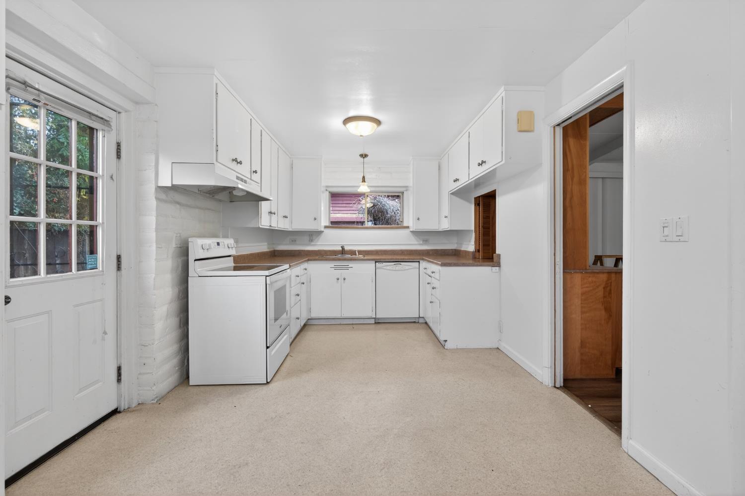 1140 West Lincoln Road Stockton, CA 95207 - Photo 14 of 45 a kitchen with cabinets and window