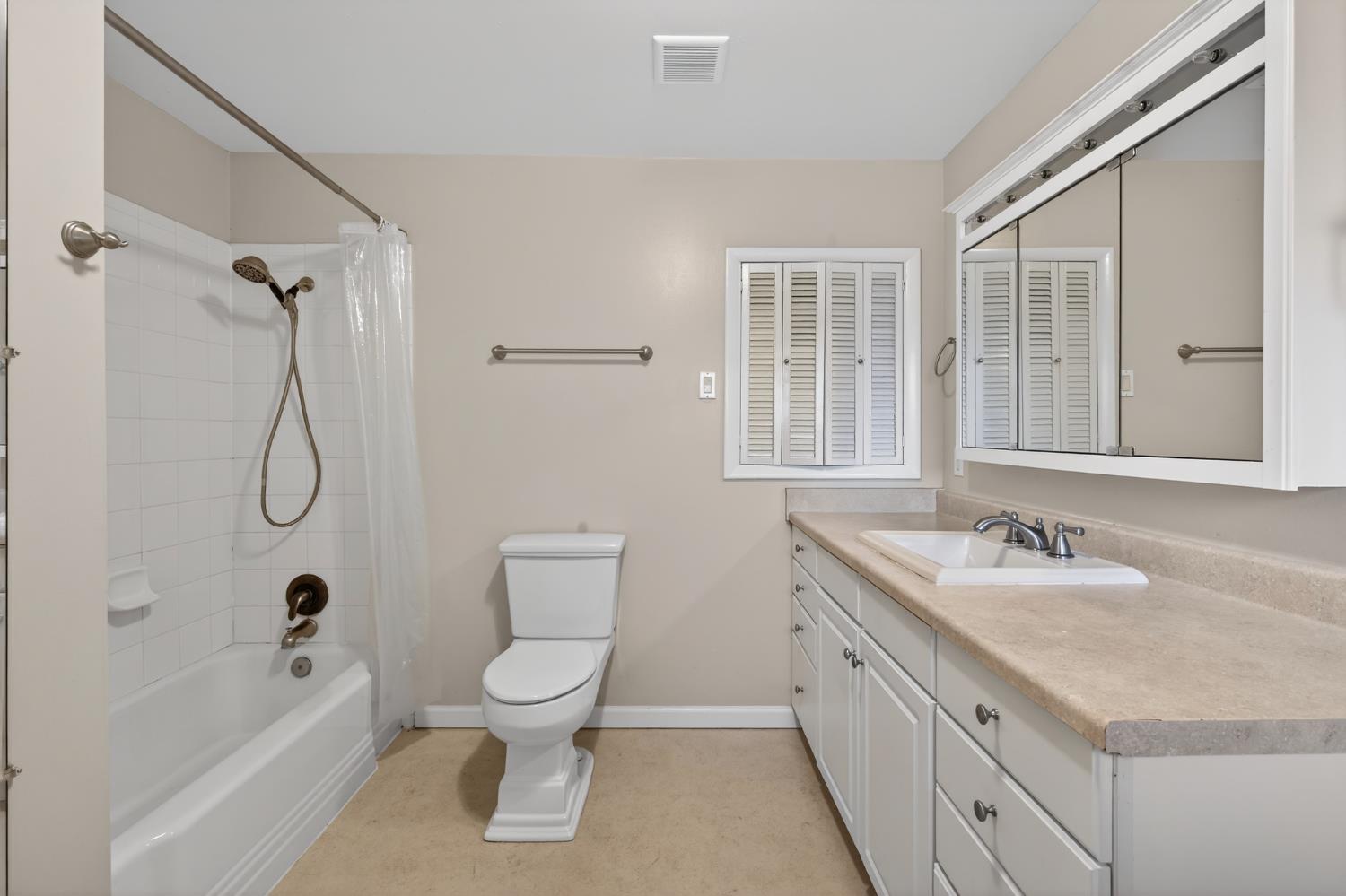 1140 West Lincoln Road Stockton, CA 95207 - Photo 18 of 45 a bathroom with a granite countertop sink a toilet and shower