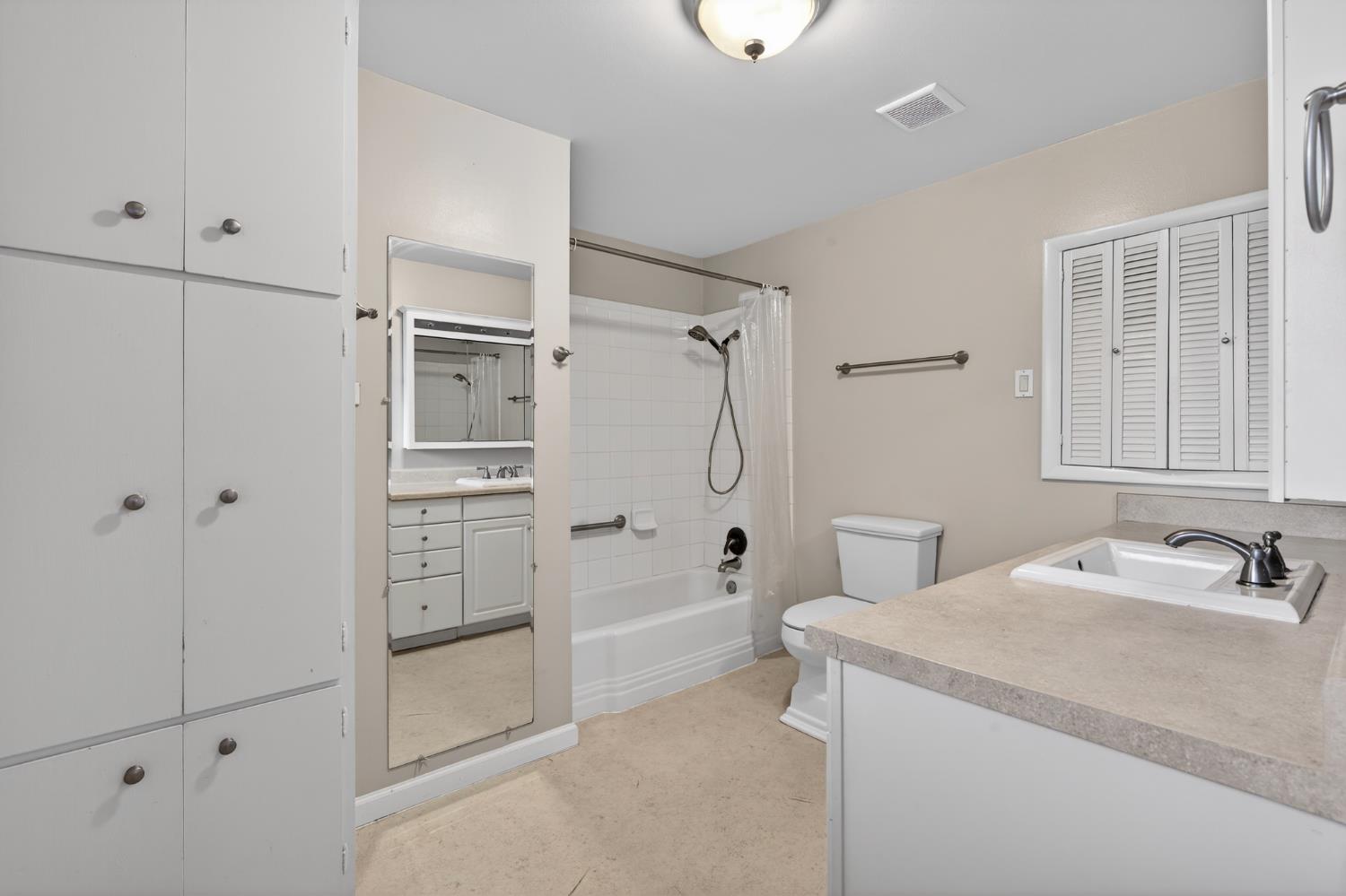 1140 West Lincoln Road Stockton, CA 95207 - Photo 20 of 45 a bathroom with a shower sink and mirror