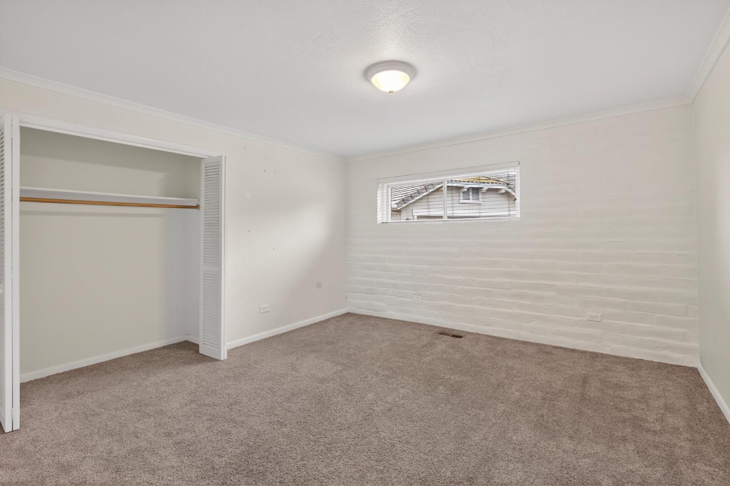 1140 West Lincoln Road Stockton, CA 95207 - Photo 21 of 45 an empty room with a window