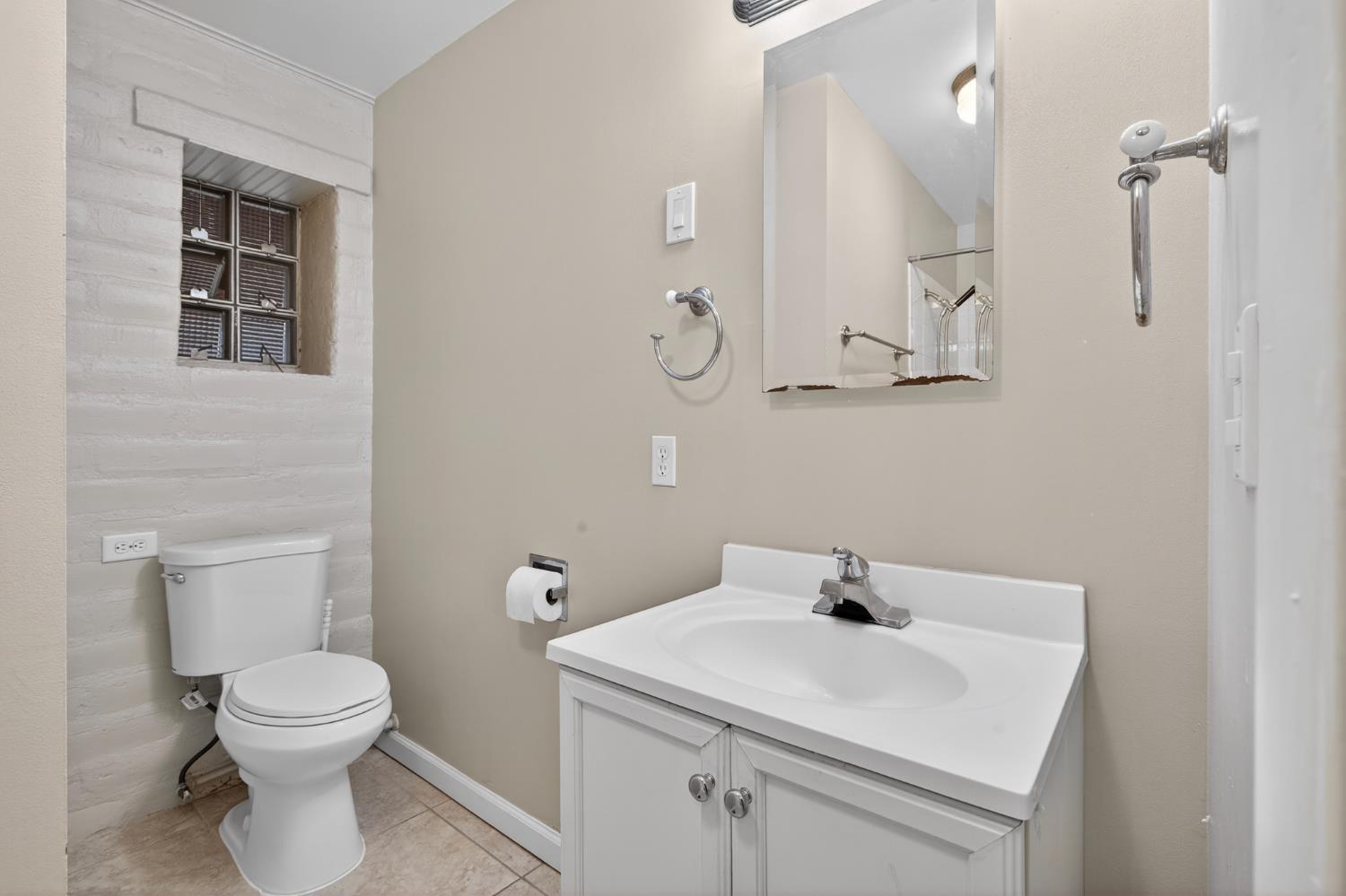 1140 West Lincoln Road Stockton, CA 95207 - Photo 28 of 45 a bathroom with a sink a toilet and a mirror