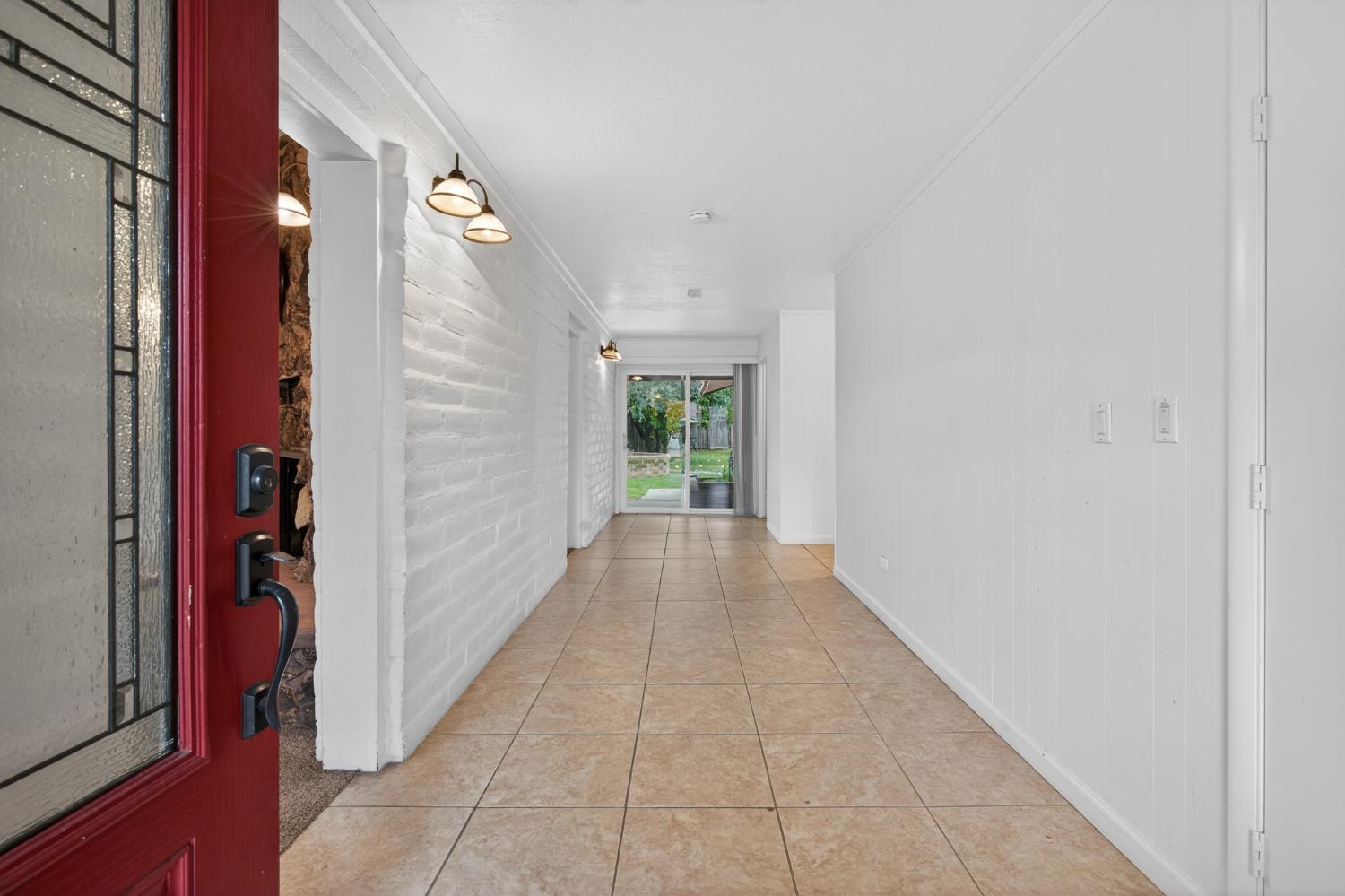 1140 West Lincoln Road Stockton, CA 95207 - Photo 6 of 45 a view of a hallway with wooden floor and a bathroom
