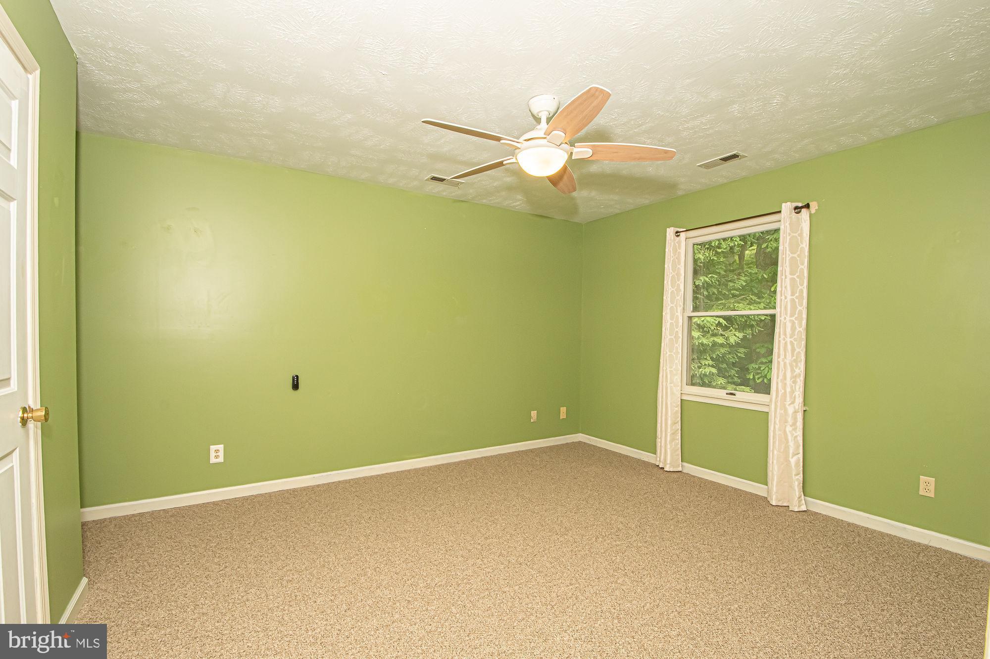 302 Parkside Road Linden, VA 22642 - Photo 16 of 30 an empty room with a window and ceiling fan