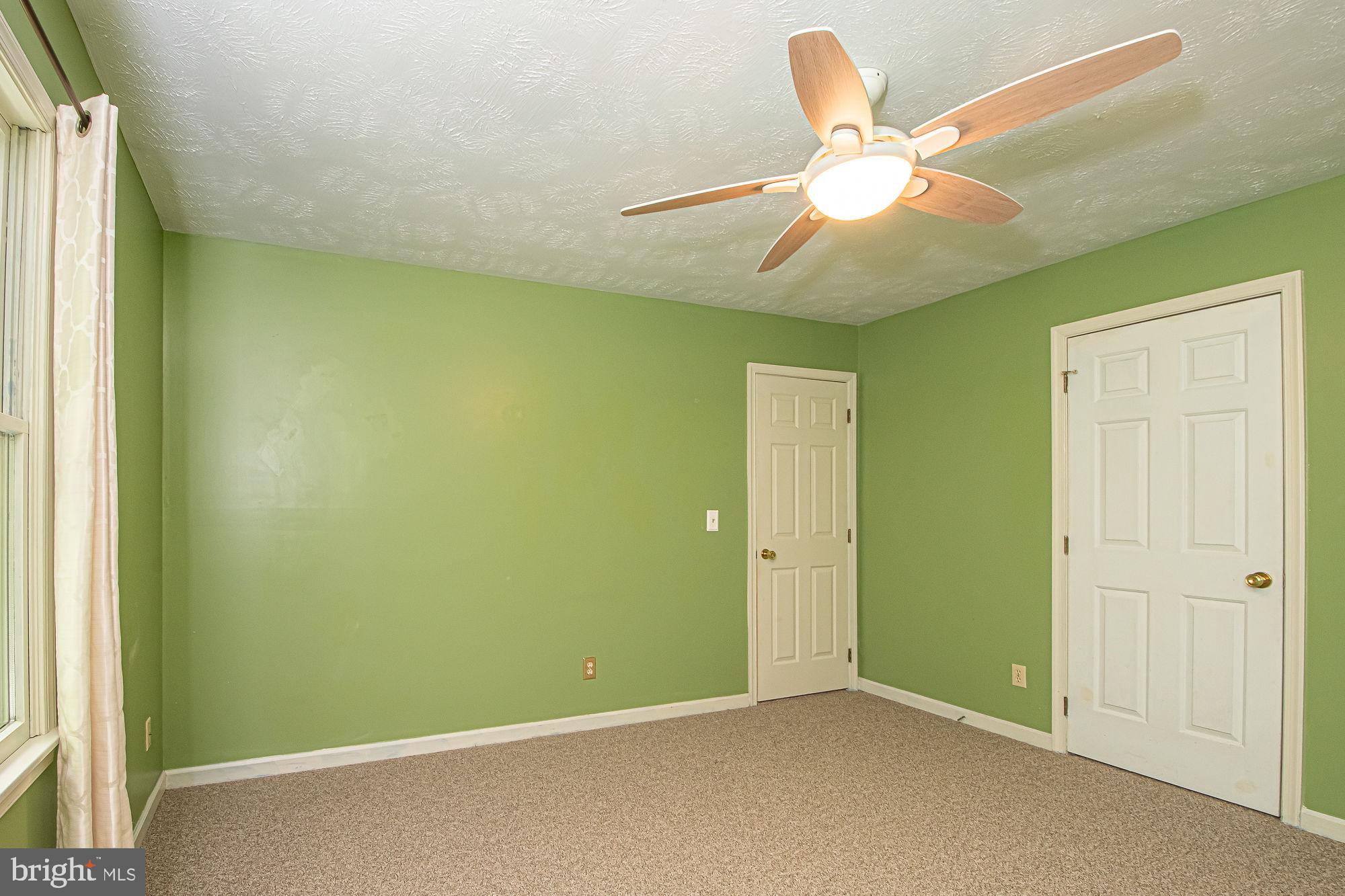 302 Parkside Road Linden, VA 22642 - Photo 18 of 30 an empty room with closet and a chandelier fan