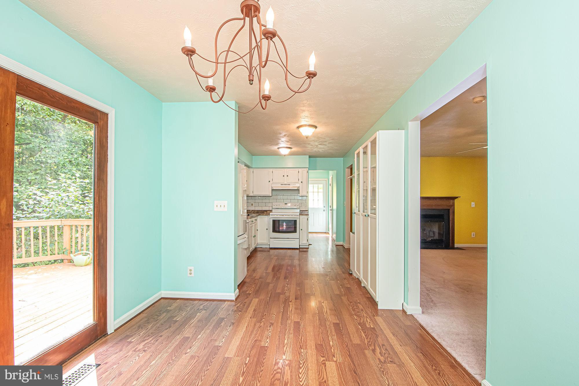 302 Parkside Road Linden, VA 22642 - Photo 10 of 30 a view of a hallway with wooden floor and a chandelier