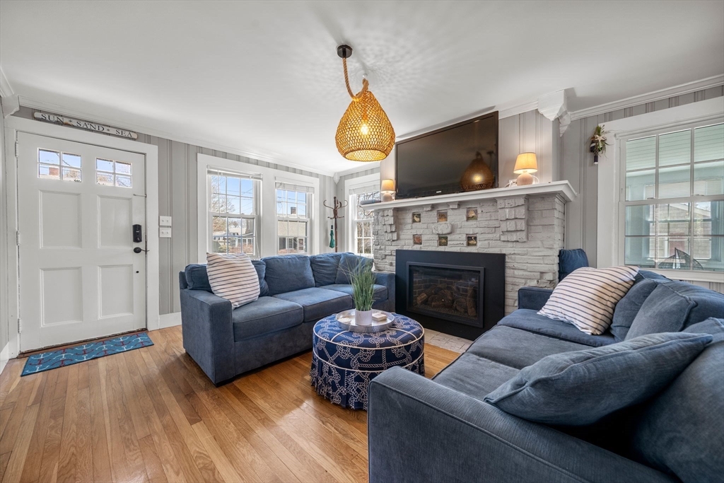 13 Hamilton Road Dennis, MA 02639 - Photo 17 of 40 a living room with furniture a flat screen tv and a fireplace