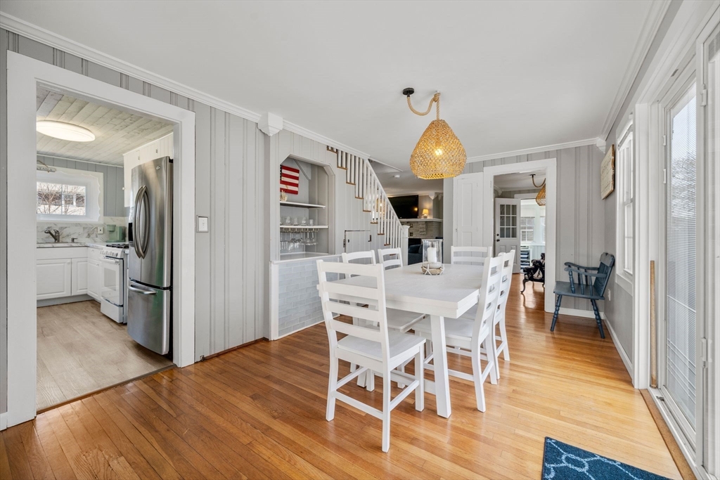 13 Hamilton Road Dennis, MA 02639 - Photo 24 of 40 a view of a dining room and livingroom with furniture wooden floor a chandelier