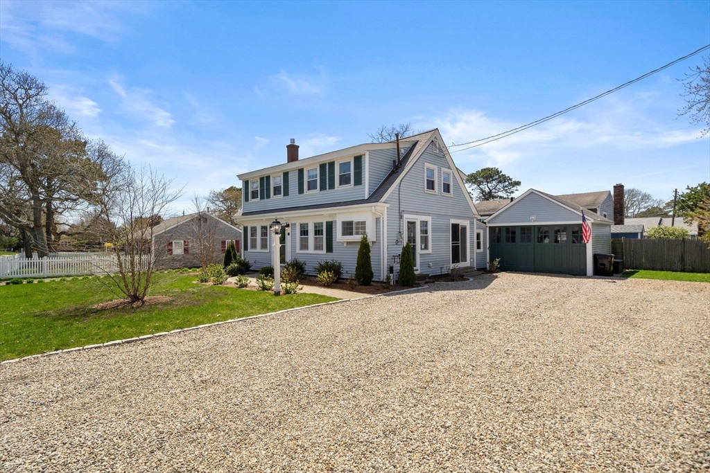 13 Hamilton Road Dennis, MA 02639 - Photo 29 of 40 a front view of a house with a yard and garage