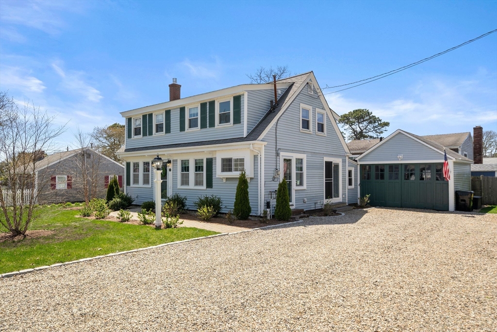 13 Hamilton Road Dennis, MA 02639 - Photo 3 of 40 a front view of a house with a yard