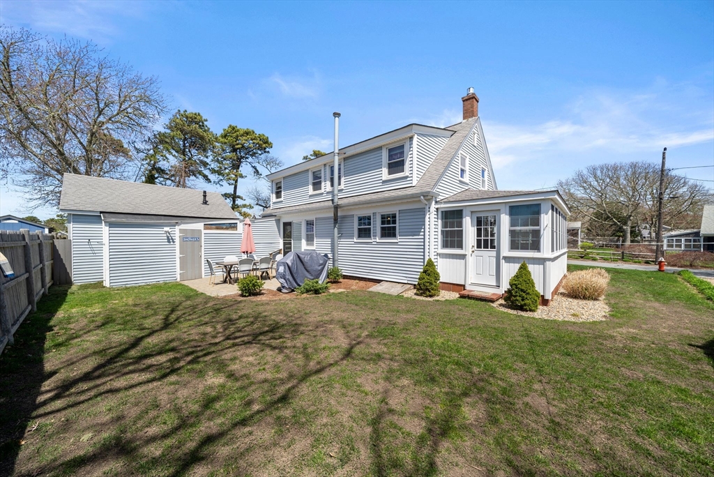13 Hamilton Road Dennis, MA 02639 - Photo 34 of 40 a view of a house with a yard patio and fire pit
