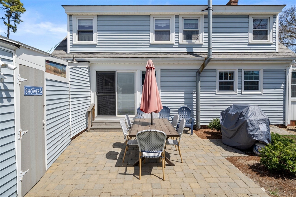 13 Hamilton Road Dennis, MA 02639 - Photo 35 of 40 a view of a patio with a table and chairs and a barbeque