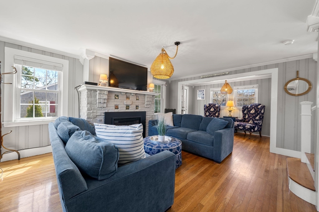 13 Hamilton Road Dennis, MA 02639 - Photo 7 of 40 a living room with furniture a flat screen tv and a fireplace