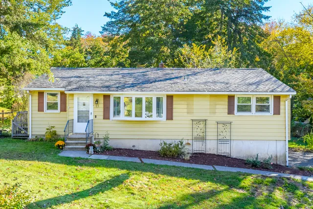 a front view of house with yard and seating space