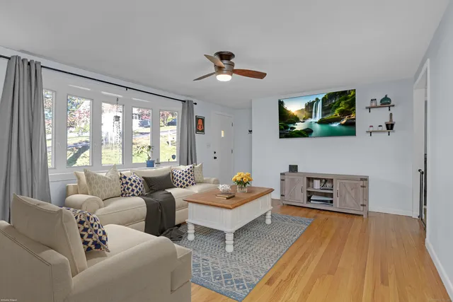 a living room with furniture and a flat screen tv