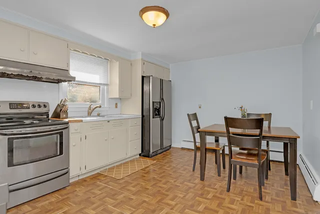 a kitchen that has a table and chair in it