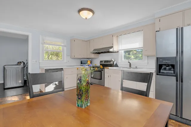 a kitchen with a sink cabinets and window