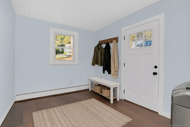 a view of a room with wooden floor and stainless steel appliances