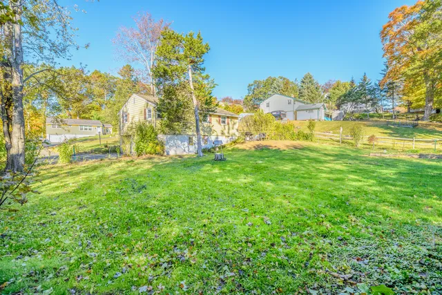 a view of yard with swimming pool and trees