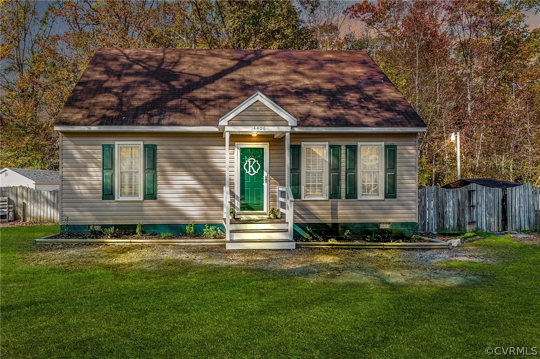 a view of house with backyard and outdoor seating