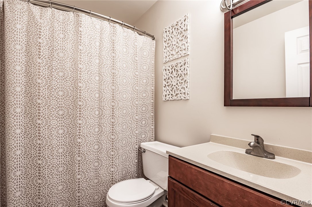 14406 Heather Stone Drive Chester, VA 23836 - Photo 18 of 29 a bathroom with a sink a toilet and a mirror