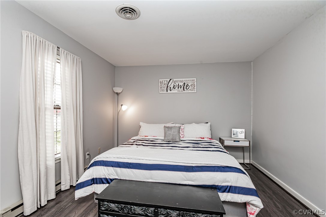 14406 Heather Stone Drive Chester, VA 23836 - Photo 19 of 29 a bedroom with a bed and wooden floor