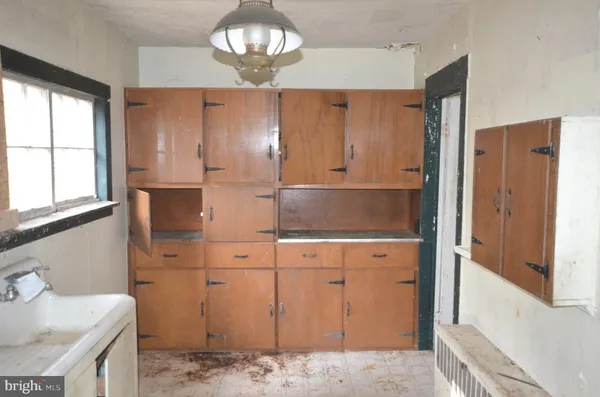 a view of kitchen with granite countertop cabinets and wooden floor