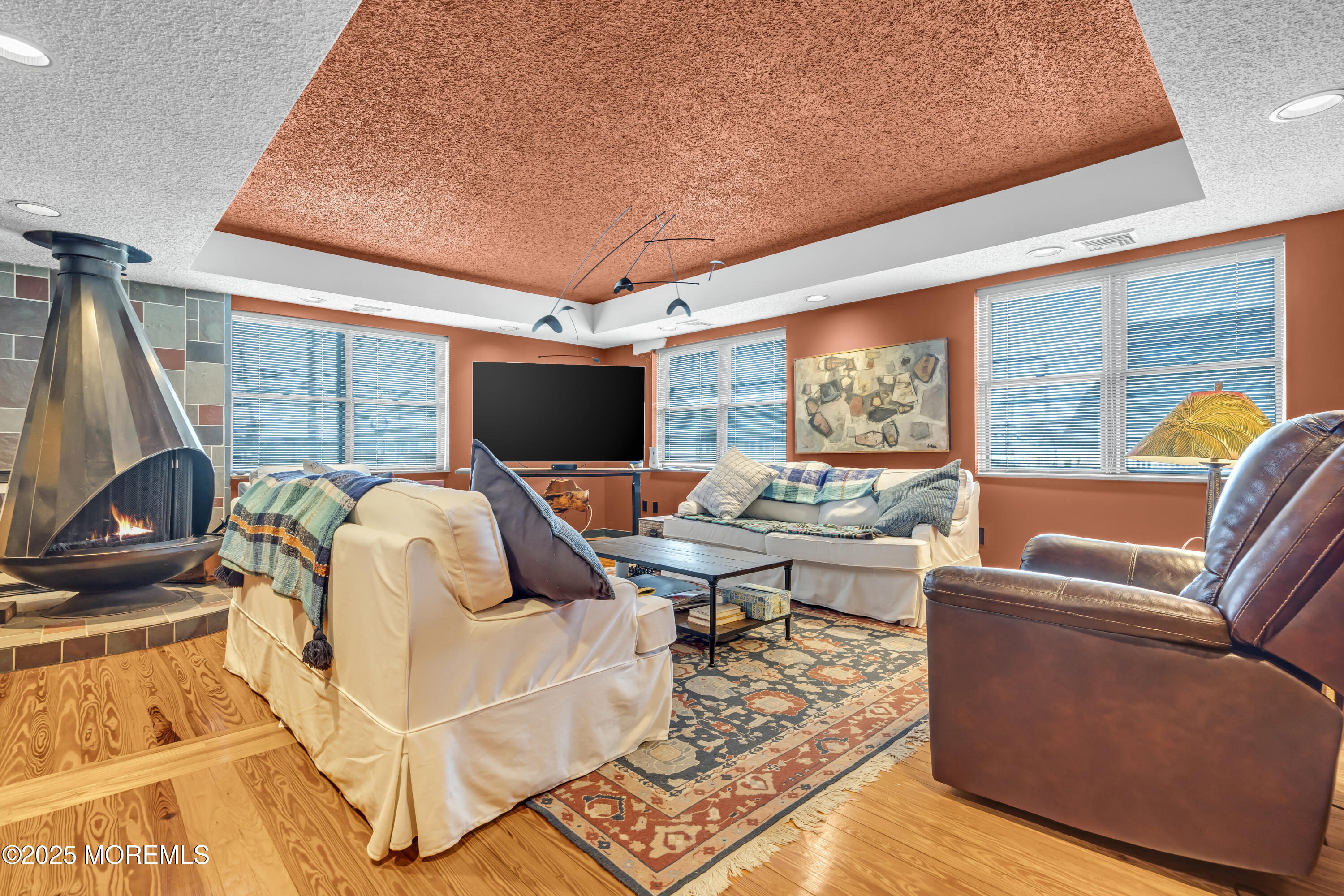 Boulevard, Unit 18 Seaside Park, NJ 08752 - Photo 15 of 60 a living room with furniture floor to ceiling window and a flat screen tv