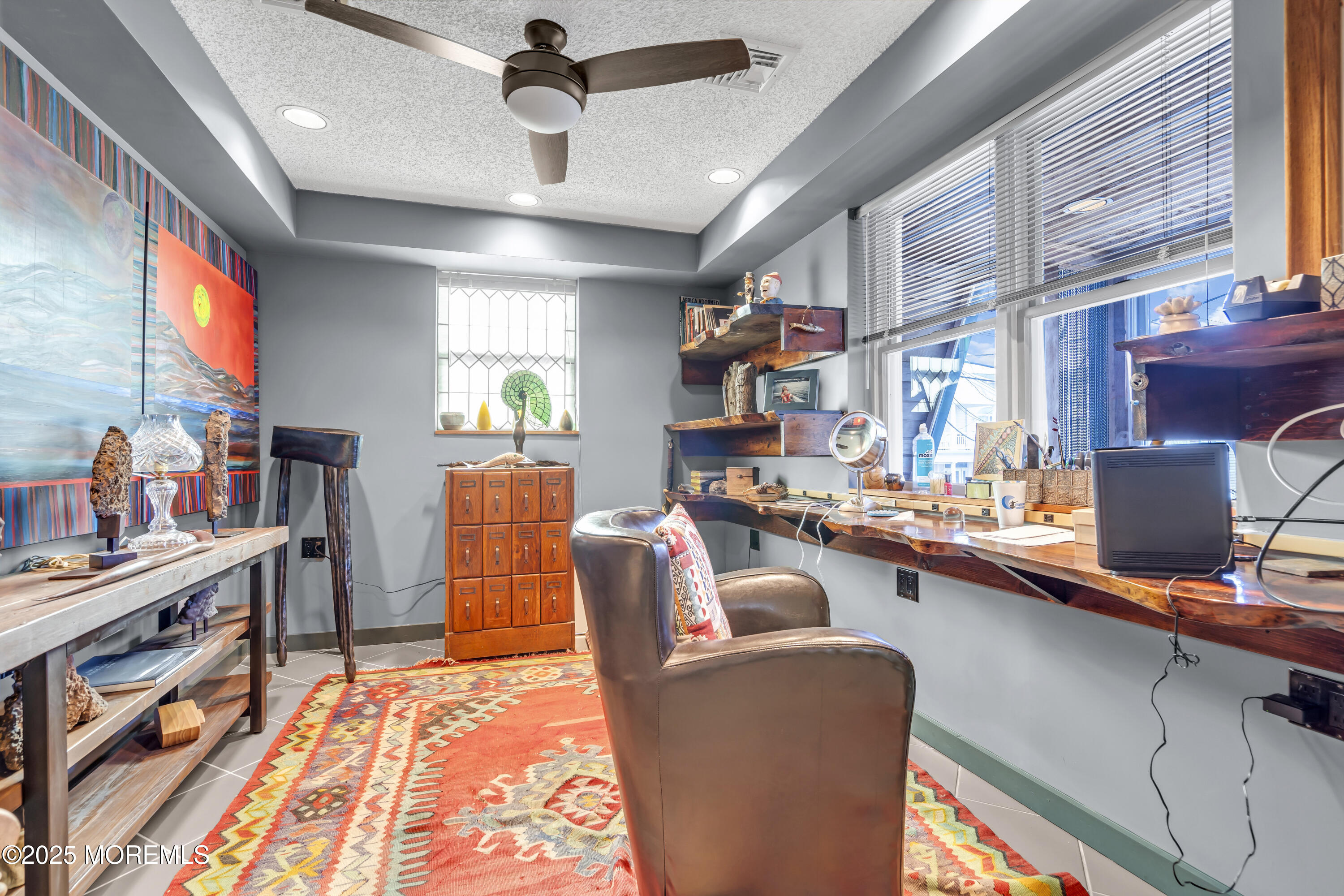 Boulevard, Unit 18 Seaside Park, NJ 08752 - Photo 20 of 60 a dining room with furniture a chandelier and a floor to ceiling window