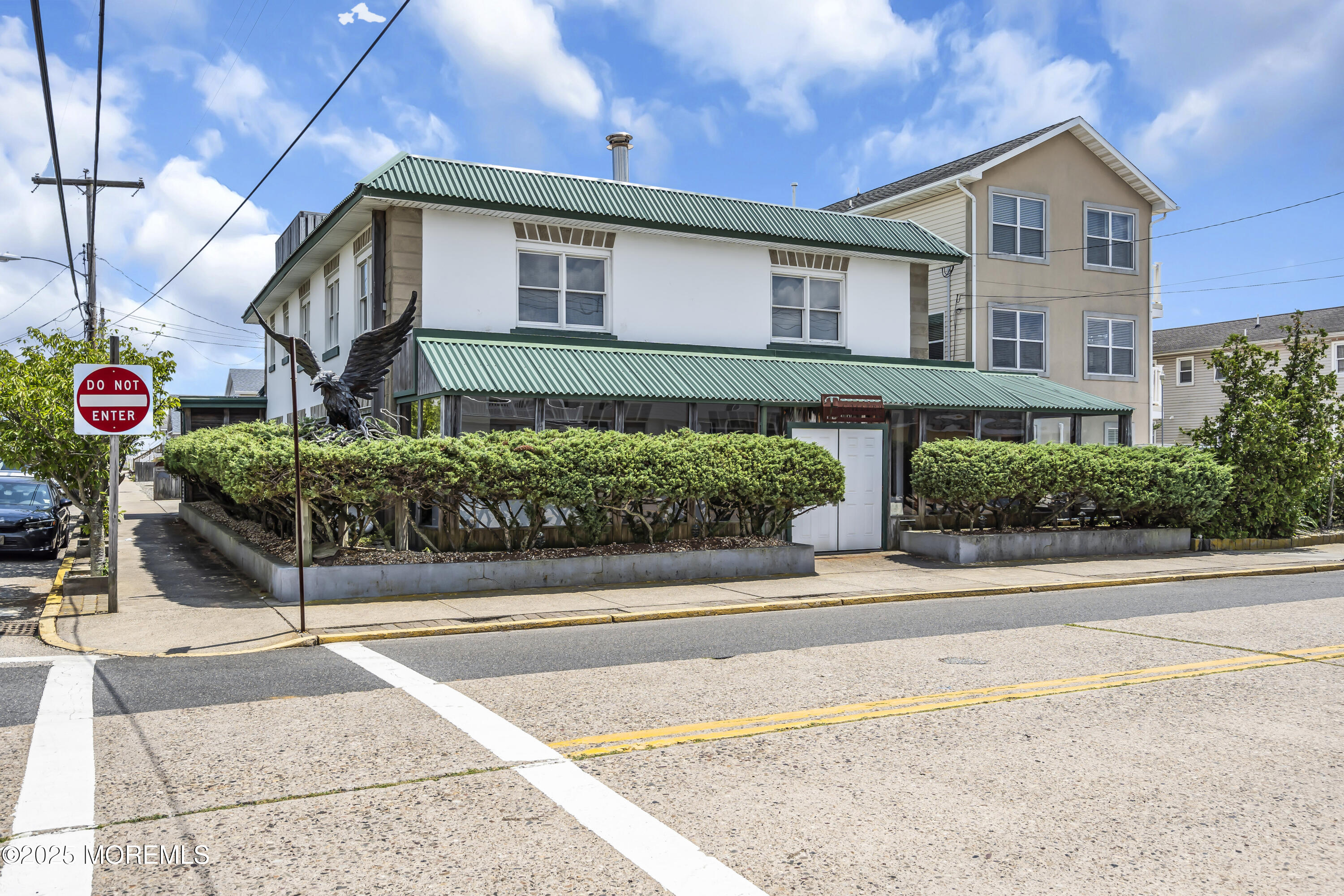 Boulevard, Unit 18 Seaside Park, NJ 08752 - Photo 3 of 60 a front view of a house with a garden and garage