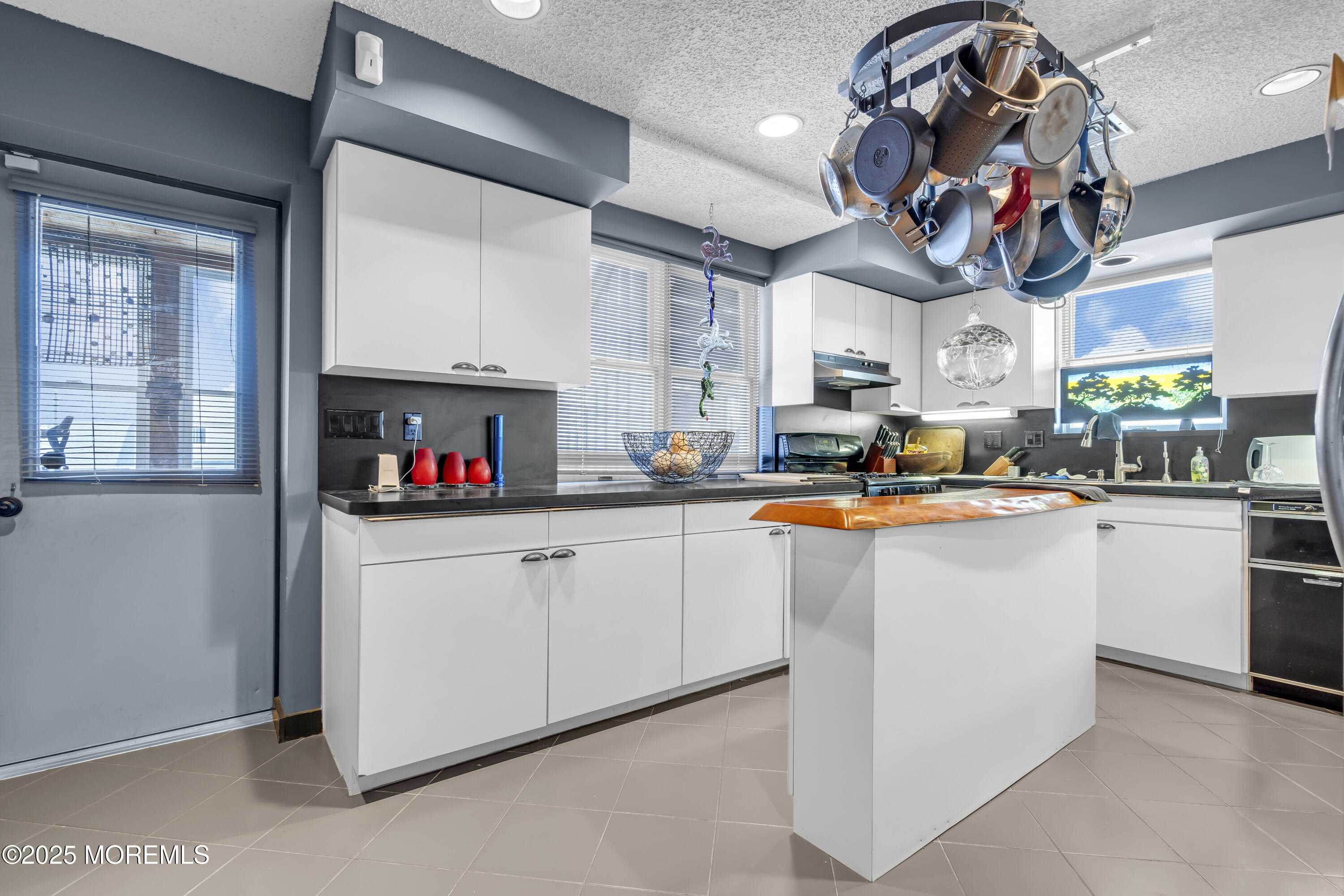 Boulevard, Unit 18 Seaside Park, NJ 08752 - Photo 7 of 60 a kitchen with stainless steel appliances granite countertop a sink dishwasher and a refrigerator with wooden floor