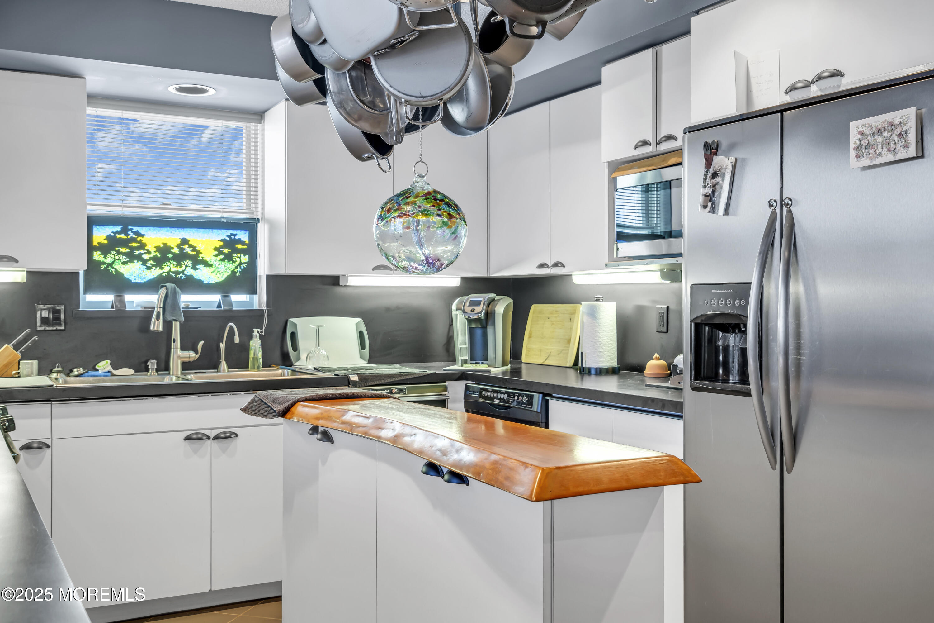 Boulevard, Unit 18 Seaside Park, NJ 08752 - Photo 9 of 60 a kitchen with stainless steel appliances granite countertop a sink and a refrigerator